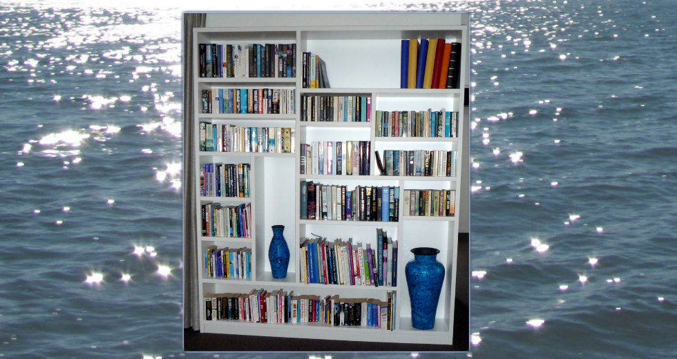 Custom white bookcase with varied shelves, books and vases