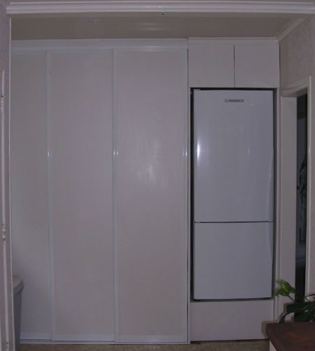 Custom laundry storage solution in a Thames kitchen. Includes full sliding doors so the laundry is hidden from view. 