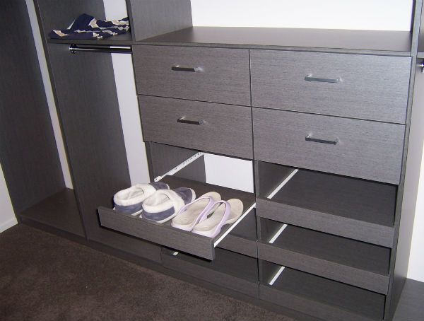 Sliding pull-out shoe shelves in a custom wardrobe. Built in the Coromandel.